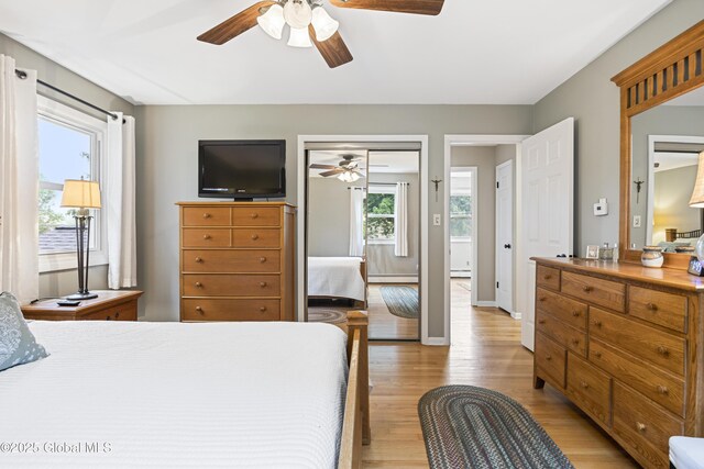 6458 Vosburgh Rd, Guilderland, NY 12009 - bedroom with light wood-type flooring, baseboard heating, and ceiling fan