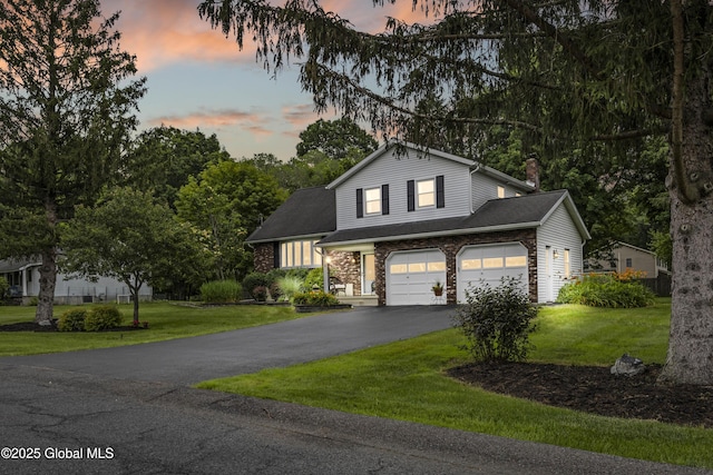 6458 Vosburgh Rd, Guilderland, NY 12009 - view of front facade featuring asphalt driveway, a yard, a chimney, and an attached garage
