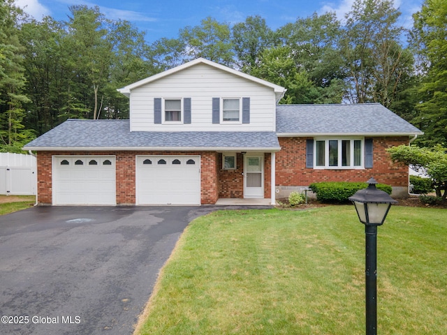 5012 Juniper Ln, Guilderland, NY 12303 - split level home featuring a shingled roof, asphalt driveway, brick siding, and a garage