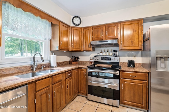 5012 Juniper Ln, Guilderland, NY 12303 - kitchen with stainless steel appliances, under cabinet range hood, brown cabinets, and light stone counters