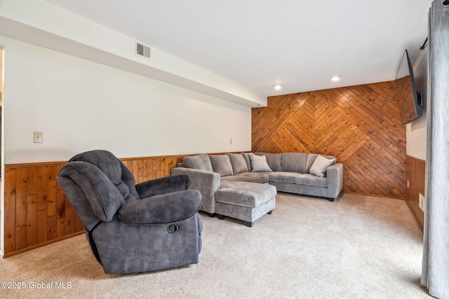5012 Juniper Ln, Guilderland, NY 12303 - carpeted living room featuring wood walls, wainscoting, an accent wall, and recessed lighting