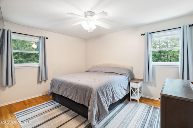 5012 Juniper Ln, Guilderland, NY 12303 - bedroom with multiple windows, wood finished floors, and ceiling fan