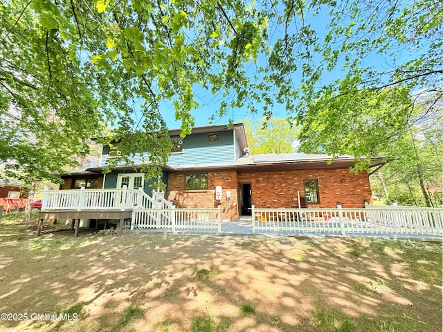 631 St Davids Ln, Niskayuna, NY 12309 - rear view of house with a wooden deck and brick siding