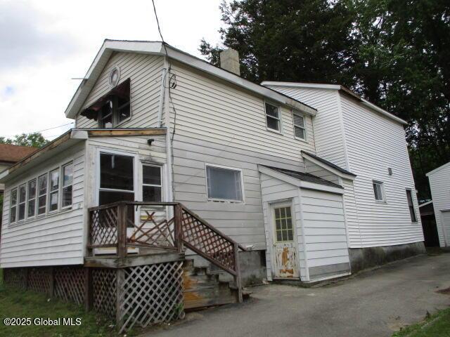 12 Chestnut St, Gloversville, NY 12078 - back of house featuring a chimney and a garage