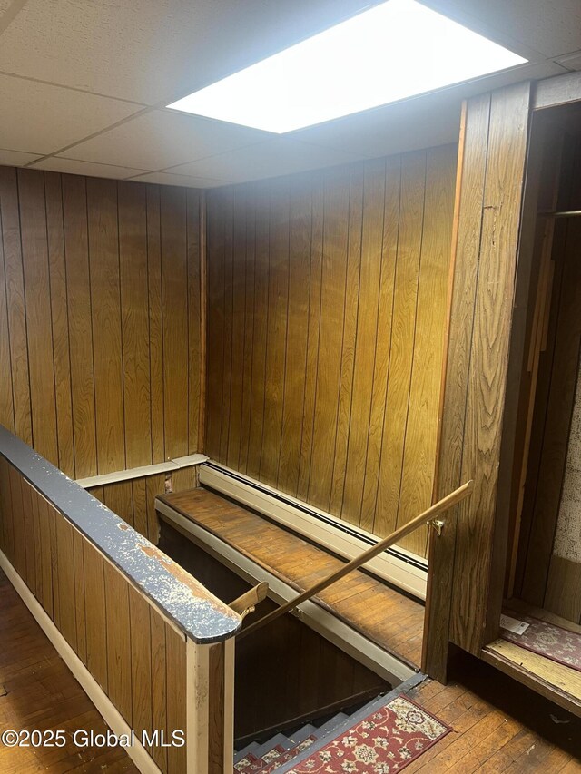 19 Williams St, Whitehall, NY 12887 - detailed view of wood finished floors, wooden walls, and baseboard heating