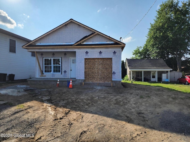 962 Florence Ave, Schenectady, NY 12303 - unfinished property with an attached garage, dirt driveway, and a porch
