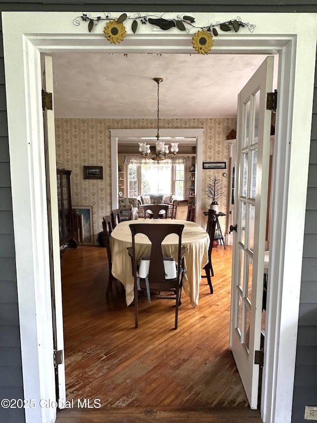 35 Walnut St, Canajoharie, NY 13317 - dining room with wallpapered walls, hardwood / wood-style floors, and a chandelier
