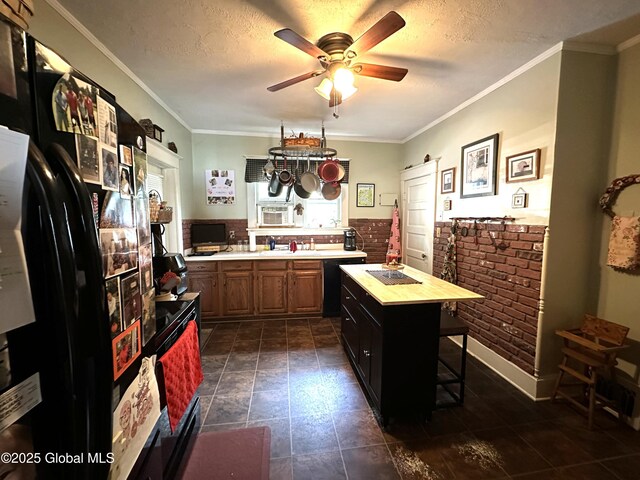 35 Walnut St, Canajoharie, NY 13317 - kitchen with black appliances, a ceiling fan, brown cabinetry, a textured ceiling, and a kitchen bar