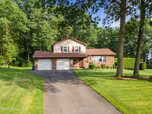 23 Tokay Ln, Colonie, NY 12309 - tri-level home featuring driveway, brick siding, a front yard, and view of wooded area