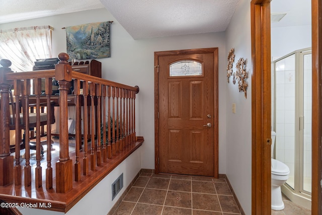 23 Tokay Ln, Colonie, NY 12309 - entryway featuring plenty of natural light, dark tile patterned floors, and a textured ceiling