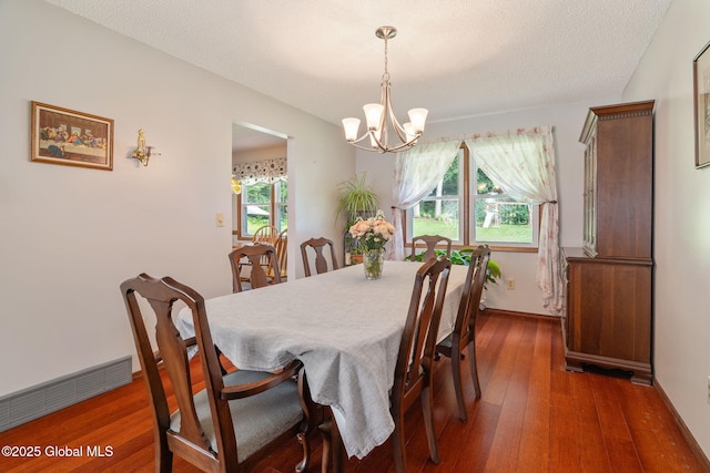 23 Tokay Ln, Colonie, NY 12309 - dining room with a chandelier, wood-type flooring, and a textured ceiling