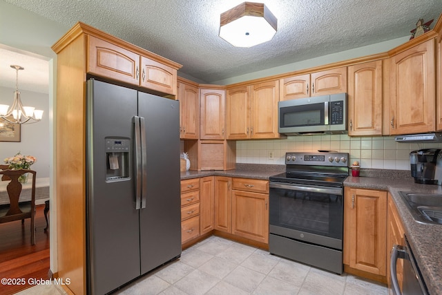 23 Tokay Ln, Colonie, NY 12309 - kitchen with appliances with stainless steel finishes, a chandelier, decorative backsplash, dark countertops, and a textured ceiling