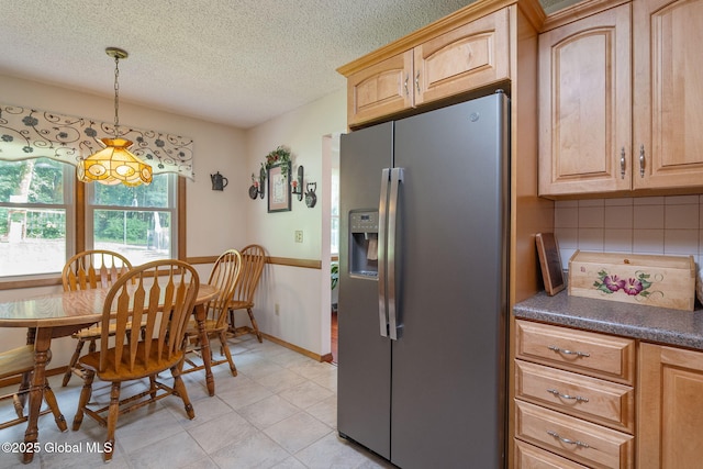 23 Tokay Ln, Colonie, NY 12309 - kitchen featuring stainless steel fridge, a textured ceiling, dark countertops, light brown cabinetry, and tasteful backsplash