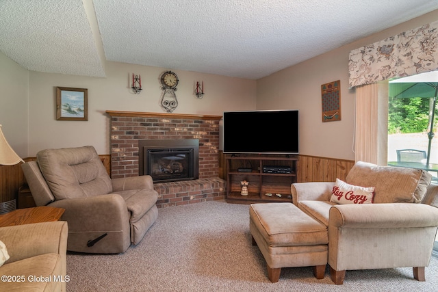 23 Tokay Ln, Colonie, NY 12309 - living room with a textured ceiling, carpet, a brick fireplace, a wainscoted wall, and wood walls