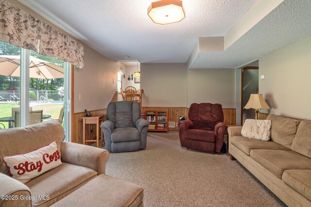 23 Tokay Ln, Colonie, NY 12309 - living room featuring wainscoting, a textured ceiling, wood walls, and carpet flooring