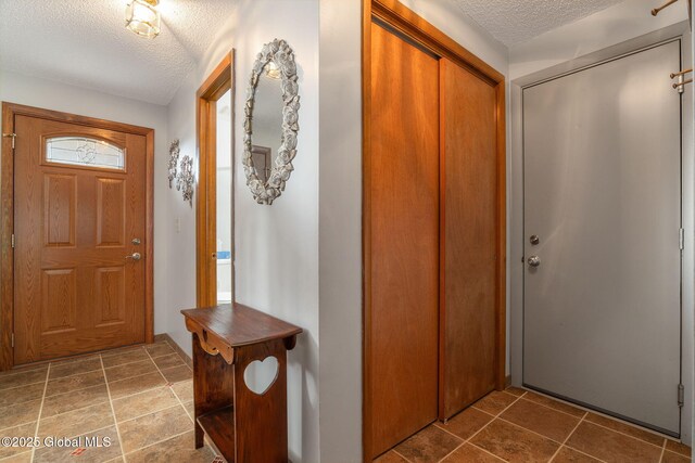 23 Tokay Ln, Colonie, NY 12309 - foyer entrance featuring a textured ceiling and tile patterned flooring