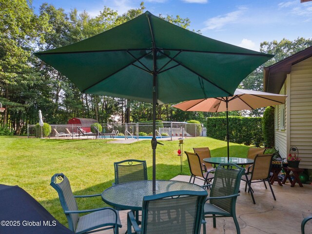 23 Tokay Ln, Colonie, NY 12309 - fenced backyard with outdoor dining area and a patio
