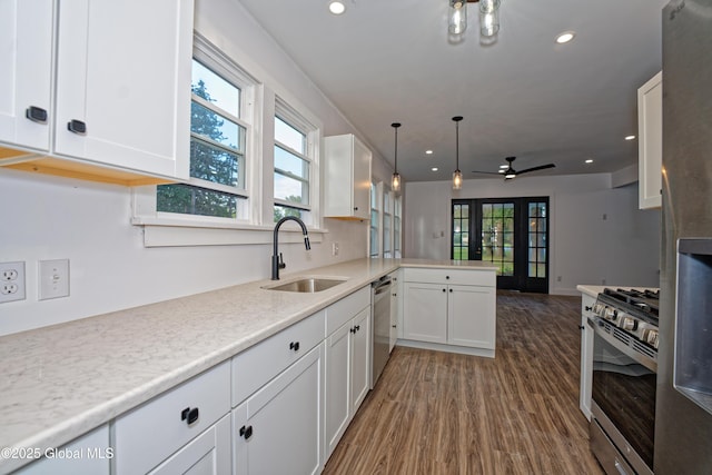280 Vley Rd, Glenville, NY 12302 - kitchen with appliances with stainless steel finishes, white cabinetry, a peninsula, wood finished floors, and recessed lighting