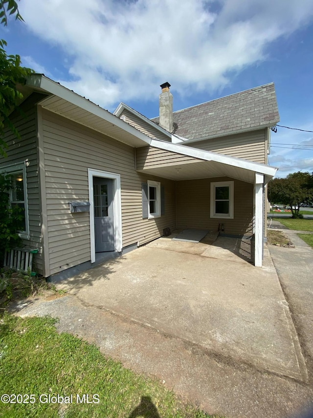 11 4th Ave, Whitehall, NY 12887 - rear view of property featuring a patio and a chimney
