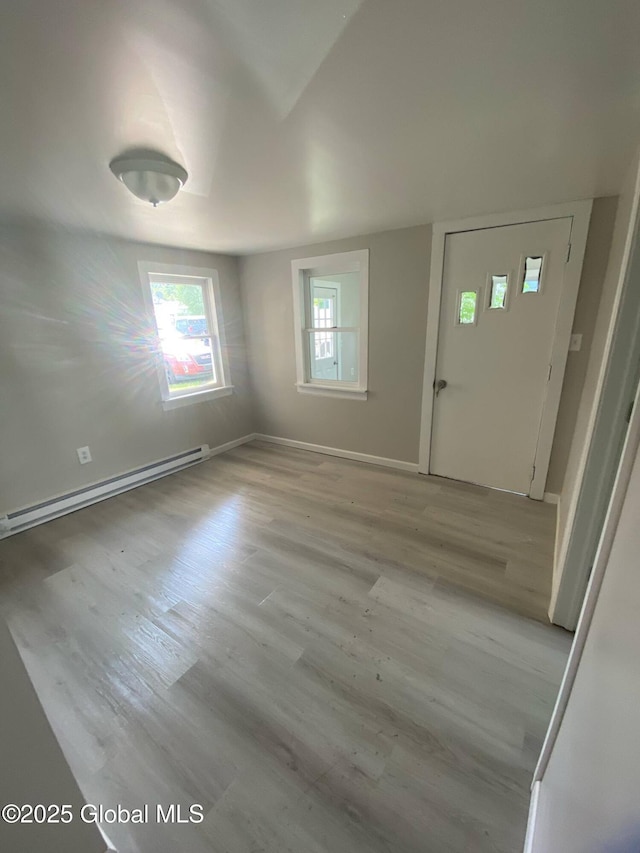 11 4th Ave, Whitehall, NY 12887 - foyer entrance with a baseboard heating unit and wood finished floors