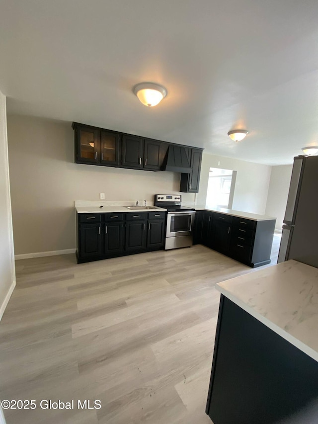 11 4th Ave, Whitehall, NY 12887 - kitchen featuring stainless steel appliances, light countertops, a peninsula, and dark cabinetry