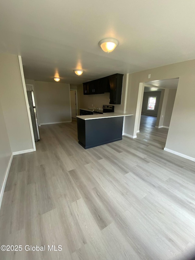 11 4th Ave, Whitehall, NY 12887 - kitchen featuring open floor plan, light wood finished floors, light countertops, and range