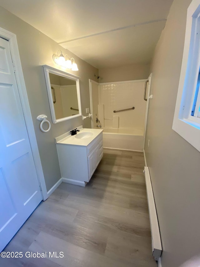 11 4th Ave, Whitehall, NY 12887 - full bath featuring baseboard heating, vanity, shower / washtub combination, and wood finished floors