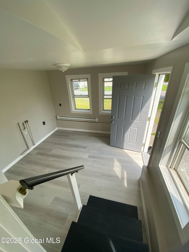 11 4th Ave, Whitehall, NY 12887 - entrance foyer featuring a baseboard heating unit, wood finished floors, and vaulted ceiling