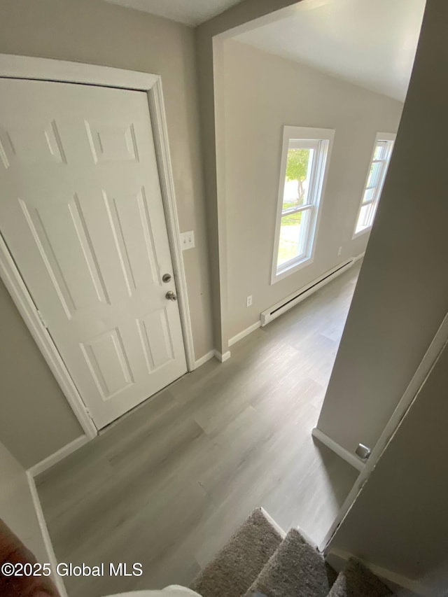 11 4th Ave, Whitehall, NY 12887 - foyer entrance featuring a baseboard heating unit and wood finished floors