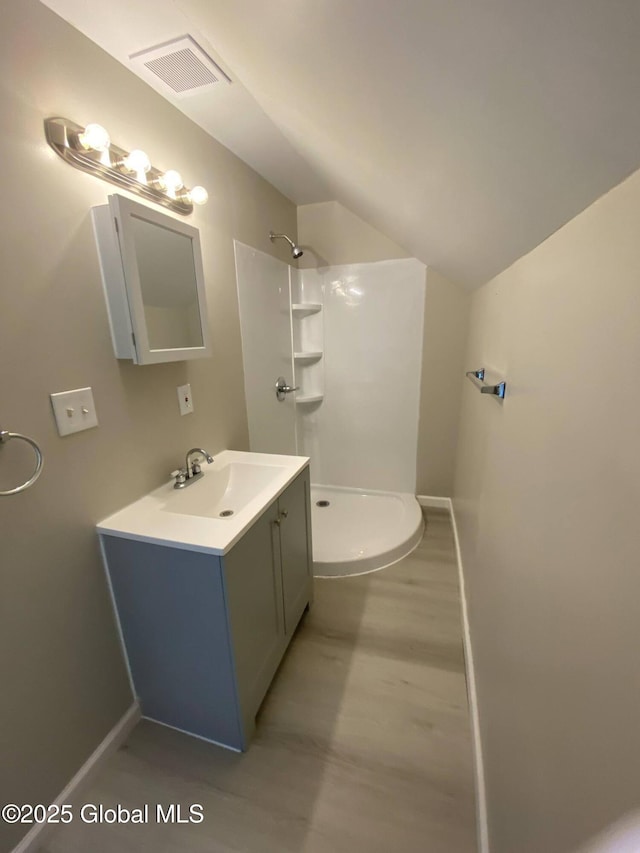 11 4th Ave, Whitehall, NY 12887 - bathroom featuring a shower, vanity, and lofted ceiling