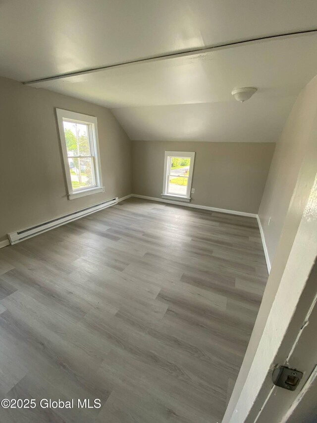 11 4th Ave, Whitehall, NY 12887 - spare room with a baseboard heating unit, lofted ceiling, and wood finished floors