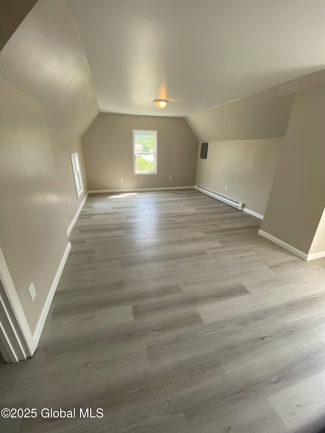 11 4th Ave, Whitehall, NY 12887 - additional living space featuring a baseboard heating unit, lofted ceiling, and wood finished floors