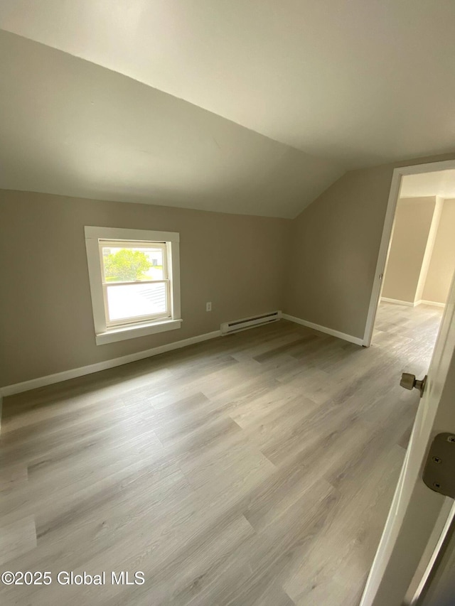 11 4th Ave, Whitehall, NY 12887 - additional living space with a baseboard radiator, vaulted ceiling, and wood finished floors
