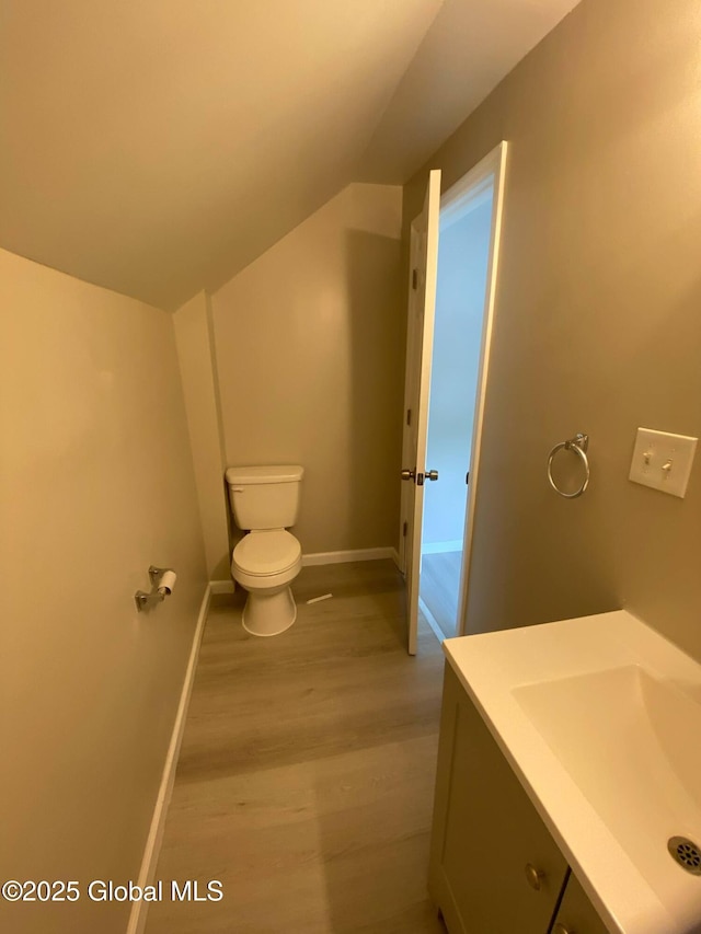 11 4th Ave, Whitehall, NY 12887 - bathroom with wood finished floors, vaulted ceiling, and vanity