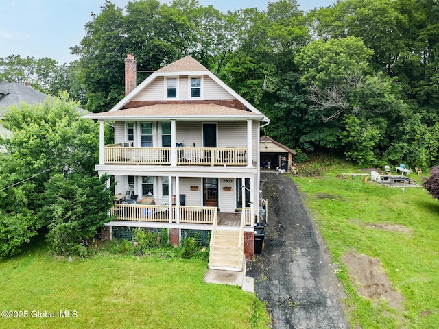 2303 Burdett Ave, Troy, NY 12180 - view of front of property with a porch, a chimney, a front lawn, and driveway