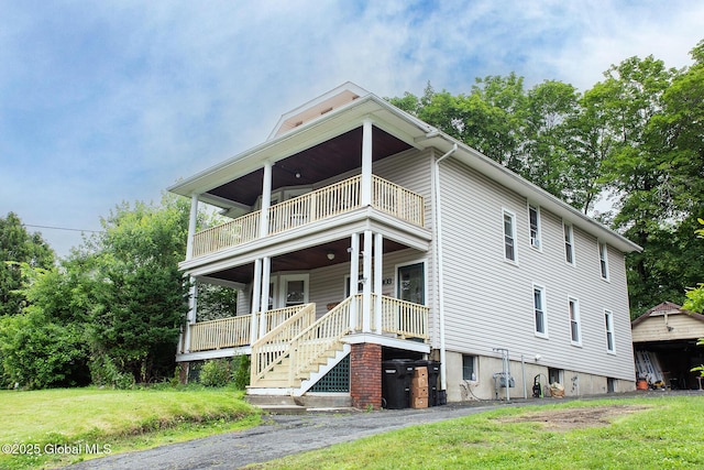 2303 Burdett Ave, Troy, NY 12180 - view of front of house with a balcony, a porch, and a front yard