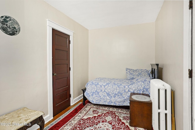 2303 Burdett Ave, Troy, NY 12180 - bedroom featuring radiator and wood finished floors