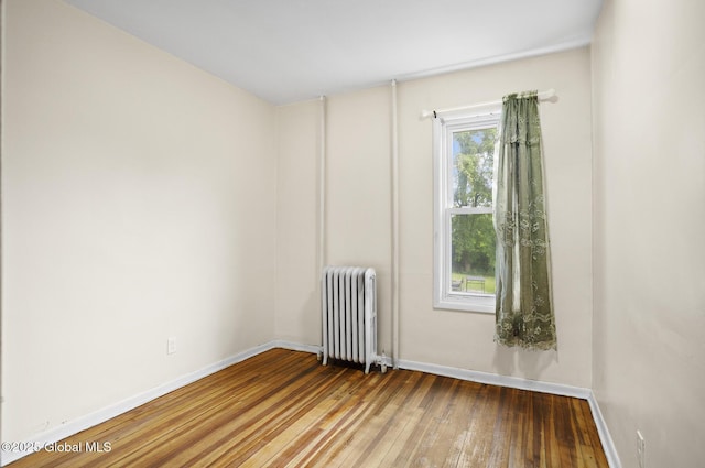 2303 Burdett Ave, Troy, NY 12180 - unfurnished room featuring radiator and hardwood / wood-style floors