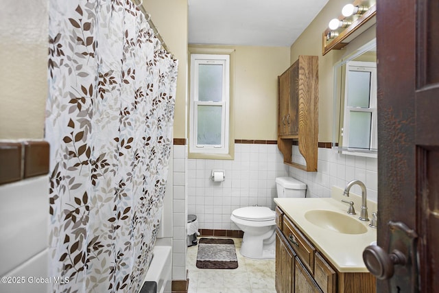 2303 Burdett Ave, Troy, NY 12180 - bathroom with vanity, shower / bath combination with curtain, tile walls, and wainscoting