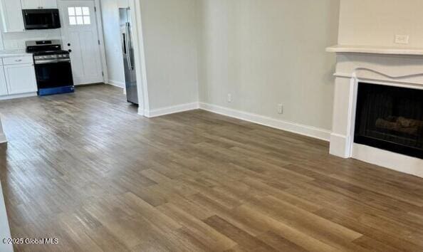 47 Chestnut St, Rensselaer, NY 12144 - unfurnished living room with dark wood-type flooring and a fireplace
