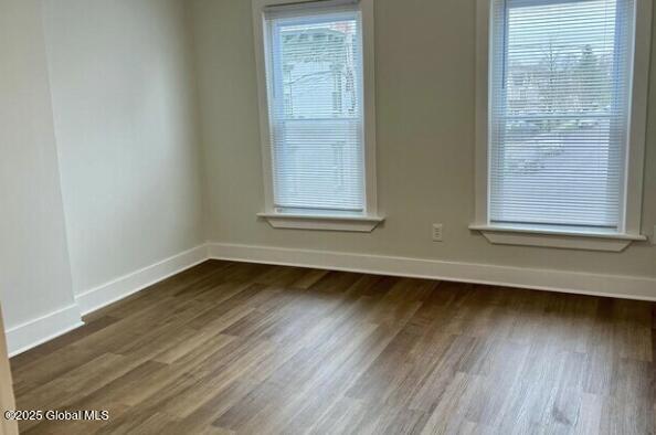 47 Chestnut St, Rensselaer, NY 12144 - unfurnished room featuring baseboards and dark wood-type flooring