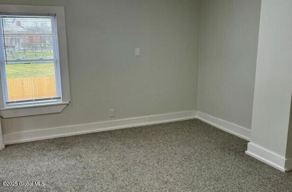 47 Chestnut St, Rensselaer, NY 12144 - spare room with dark carpet and baseboards
