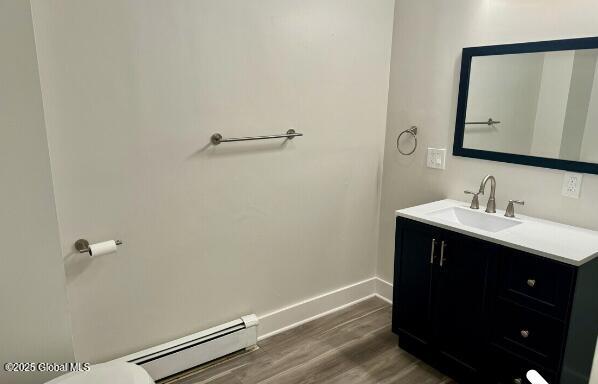 47 Chestnut St, Rensselaer, NY 12144 - bathroom with a baseboard radiator, vanity, and wood finished floors
