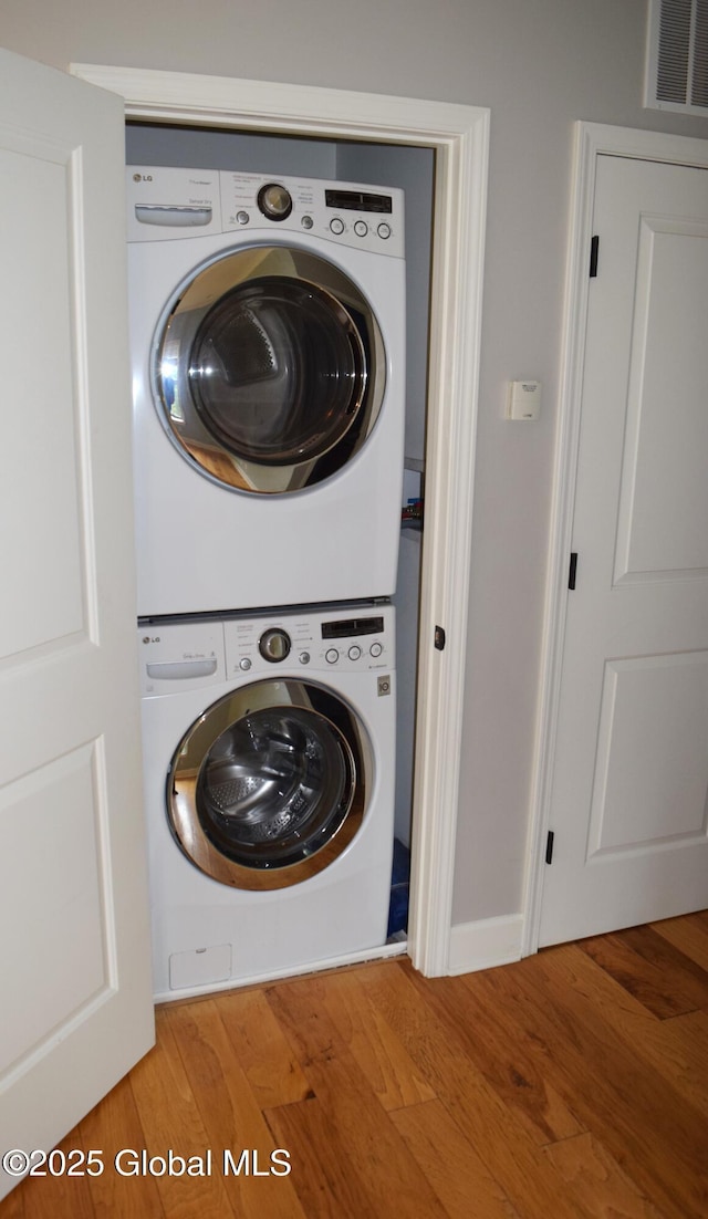 9 Lancaster Pl, Milton, NY 12020 - laundry area featuring estacked washer and dryer and wood finished floors