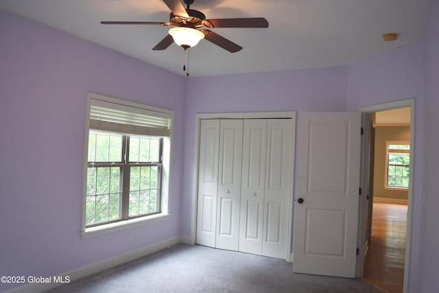 9 Lancaster Pl, Milton, NY 12020 - unfurnished bedroom featuring multiple windows, carpet flooring, a closet, and a ceiling fan