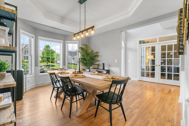 11 Fairview Ln, Halfmoon, NY 12118 - dining space featuring a tray ceiling, light wood-style flooring, crown molding, and french doors