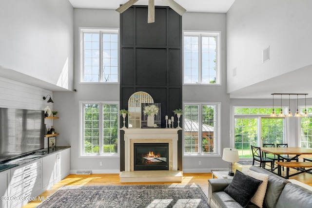 11 Fairview Ln, Halfmoon, NY 12118 - living area with a towering ceiling, healthy amount of natural light, and light wood finished floors