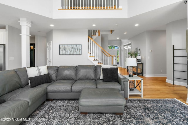 11 Fairview Ln, Halfmoon, NY 12118 - living area with wood finished floors, stairs, recessed lighting, and decorative columns