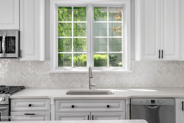 11 Fairview Ln, Halfmoon, NY 12118 - kitchen featuring stainless steel appliances, white cabinetry, tasteful backsplash, and light countertops
