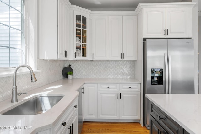 11 Fairview Ln, Halfmoon, NY 12118 - kitchen featuring glass insert cabinets, stainless steel refrigerator with ice dispenser, decorative backsplash, and white cabinets